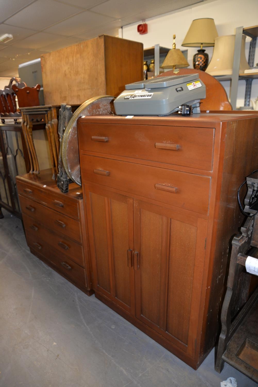 A MAHOGANY PLY PANELLED MID-CENTURY BEDROOM SUITE OF TWO PIECES, VIZ, A MILLINERY CABINET AND