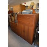 A MAHOGANY PLY PANELLED MID-CENTURY BEDROOM SUITE OF TWO PIECES, VIZ, A MILLINERY CABINET AND