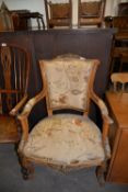 A LADY'S FRENCH STYLE OPEN ARMCHAIR, UPHOLSTERED IN FLORAL FABRIC, THE ARMS, LEGS AND BACK WITH