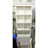 TALL PINE, PAINTED WHITE BOOKCASE, HAVING CUBE SHELVING AND CUPBOARD DOORS, ON PLINTH BASE, 208cm