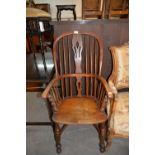 A COUNTRY WINDSOR ARMCHAIR, WITH CRINOLINE STRETCHER