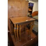 A NEST OF THREE MAHOGANY OBLONG COFFEE TABLES, ON CABRIOLE LEGS AND A POLISHED WOOD PERIODICAL RACK