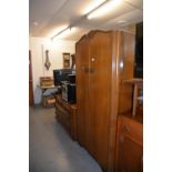 A MID-CENTURY MEDIUM OAK BEDROOM SUITE OF TWO PIECES, VIZ, A GENT’S SEMI-FITTED WARDROBE AND A