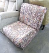 AN ARMLESS LOW BOUDOIR EASY CHAIR, FOLDING OUT TO FORM A GUEST BED, COVERED IN FOLIATE SCROLL