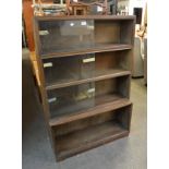 A 'MINTY' FOUR TIER SECTIONAL LIBRARY BOOKCASE, HAVING GLASS SLIDING DOORS (BOTTOM GLASS DOORS