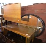 AN OVAL HALL MIRROR, IN MOULDED WOODEN FRAME; A TEAK OBLONG COFFEE TABLE, ON TRESTLE END SUPPORTS