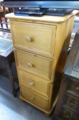 A TALL NARROW PINE CHEST OF FOUR DEEP DRAWERS