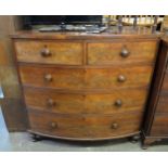 AN EARLY 19TH CENTURY FIGURED MAHOGANY BOW FRONTED CHEST OF TWO SHORT AND THREE LONG DRAWERS, WITH