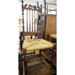 A VICTORIAN OAK SPINDLE BACK, RUSH SEATED DINING CHAIR, HAVING TURNED BACK SUPPORTS, AND TWO
