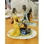 E. TELTA, ITALIAN FAIENCE GROUP OF TWO STYLISED GEISHA, ON OVAL BASE