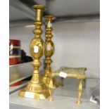 PAIR OF NINETEENTH CENTURY OVERSIZED BRASS CANDLESTICKS, WITH EJECTORS AND A BRASS TRIVET (3)