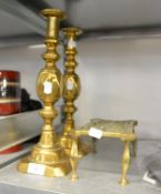 PAIR OF NINETEENTH CENTURY OVERSIZED BRASS CANDLESTICKS, WITH EJECTORS AND A BRASS TRIVET (3)