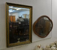 AN OBLONG WALL MIRROR IN EMBOSSED GILT FRAME AND AN OVAL SHAPED WALL MIRROR (2)