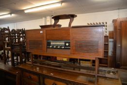 A MID-CENTURY TEAK LONG LOW RADIOGRAM, HAVING A GARRARD 1025 TURNTABLE AND WAVE-CHANGE TUNER