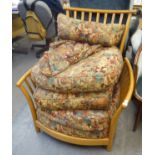 A LARGE LIGHT OAK FRAMED SPINDLED EASY ARMCHAIR, WITH LOOSE BACK CUSHIONS, ETC. COVERED TAPESTRY (