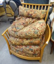 A LARGE LIGHT OAK FRAMED SPINDLED EASY ARMCHAIR, WITH LOOSE BACK CUSHIONS, ETC. COVERED TAPESTRY (