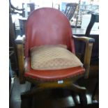 A STURDY 1930S OAK SMALL EASY ARMCHAIR, UPHOLSTERED ARCH SHAPED BACK AND THE SEAT COVERED IN TAN