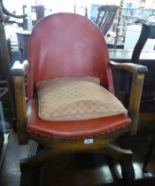 A STURDY 1930S OAK SMALL EASY ARMCHAIR, UPHOLSTERED ARCH SHAPED BACK AND THE SEAT COVERED IN TAN