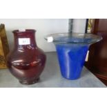 A RUBY GLASS OVULAR VASE AND A BLUE MOTTLED STUDIO GLASS TAPERING VASE, WITH FLARED LIP (2)