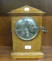 AN OAK MANTEL OR BRACKET CLOCK WITH 8 DAYS STRIKING AND CHIMING MOVEMENT