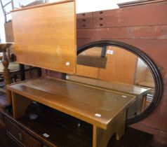 AN OVAL HALL MIRROR, IN MOULDED WOODEN FRAME; A TEAK OBLONG COFFEE TABLE, ON TRESTLE END SUPPORTS