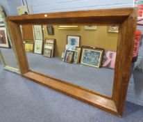 A LARGE HARDWOOD MIRROR, SET IN CHAMFERRED FRAME, 2m WIDE