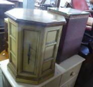 A SMALL PAINTED WOOD OCTAGONAL SHADED CUPBOARD WITH POLISHED WOOD TOP AND  A LLOYD LOOM STYLE