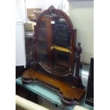 A LARGE AND HANDSOME VICTORIAN CARVED MAHOGANY SWING TOILET MIRROR, ON PLATFORM BASE