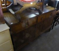 1920’S OAK SIDEBOARD WITH LOW ARCHED BACK PANEL, TWO FRIEZE DRAWERS FACED AS THREE DRAWERS, OVER