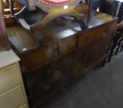 1920’S OAK SIDEBOARD WITH LOW ARCHED BACK PANEL, TWO FRIEZE DRAWERS FACED AS THREE DRAWERS, OVER