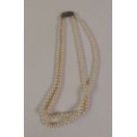 DOUBLE STRAND GRADUATED CULTURED PEARL NECKLACE, with a marcasite set clasp, 42cm long