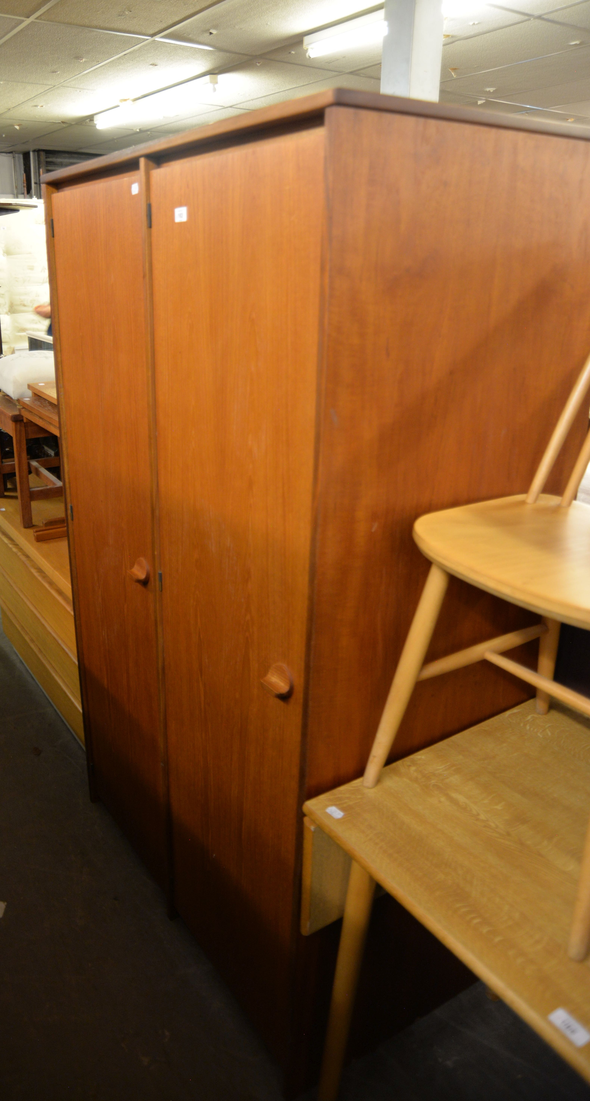 A MID-CENTURY TEAK TWO-DOOR WARDROBE AND A TEAK AND WHITE MELAMINE LONG, LOW DRESSING TABLE WITH