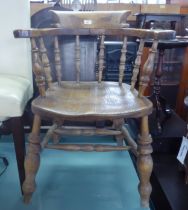 A PAIR OF ELM TUB SHAPED WINDSOR ARMCHAIRS, EACH WITH SPINDLE BACK AND PANEL SEAT, ON TURNED