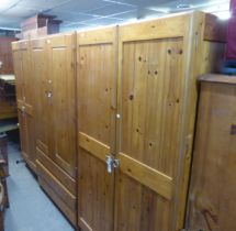 A MODERN PINE TWO DOOR WARDROBE, HAVING THREE DRAWERS BELOW, A PINE T & G TWO DOOR WARDROBE AND