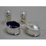 INTER-WAR YEARS SILVER FOUR PIECE CONDIMENT SET comprising a pair of pepperettes, salt cellar and