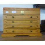 LIGHT OAK COLLECTORS/JEWELLERY CABINET WITH LIFT-UP TOP AND FOUR DRAWERS