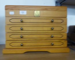 LIGHT OAK COLLECTORS/JEWELLERY CABINET WITH LIFT-UP TOP AND FOUR DRAWERS