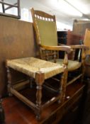 AN OAK OPEN ARMCHAIR, HAVING FABRIC COVERED BACK AND SEAT (POSSIBLY A ROCKING CHAIR), AND AN