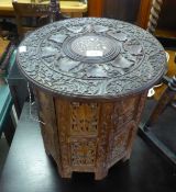 A MIDDLE EASTERN CIRCULAR TOP FOLDING OCCASIONAL TABLE WITH INLAY DECORATION