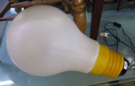 A NOVELTY FLOOR LAMP IN THE FORM OF A GIANT ELECTRIC LIGHT BULB