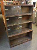 A 'MINTY' FOUR TIER SECTIONAL LIBRARY BOOKCASE, HAVING GLASS SLIDING DOORS (BOTTOM GLASS DOORS