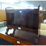 AN OVAL WALL MIRROR, IN FANCY GILT FRAME AND A MAHOGANY PERIODICAL RACK (2)