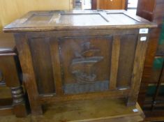 A SMALL JACOBEAN STYLE OAK COFFER, WITH FRAMED THREE PANEL LID, WITH IRON BUTTERFLY HINGES, THE