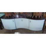 A CALLIGARIS SERPENTINE TWO DOOR GLASS FRONTED SIDEBOARD, HAVING GLASS CENTRAL DRAWER