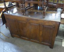 A LARGE 18TH CENTURY OAK COFFER WITH FOUR PANEL FRONT