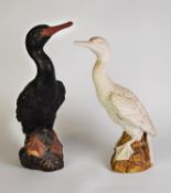 JOHN BOURDEAUX, SCILLY ISLES POTTERY, TWO BISQUE MODELS OF CORMORANTS, one with brown glazed base,