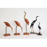 TWO CARVED HORN MODELS OF HERONS, 13 ¼” (33.7cm) and smaller, together with a SIMILAR SET OF THREE