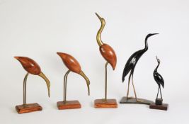 TWO CARVED HORN MODELS OF HERONS, 13 ¼” (33.7cm) and smaller, together with a SIMILAR SET OF THREE