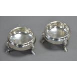 PAIR OF EARLY GEORGE III SILVER CAULDRON-SHAPE SALT-CELLARS with cabled rims, each on three
