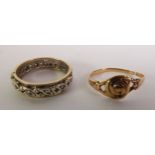 WHITE STONE ETERNITY RING, marked ‘9CT’, ring size J1/2; and a FLORAL RING, unmarked (cut), 4.6g
